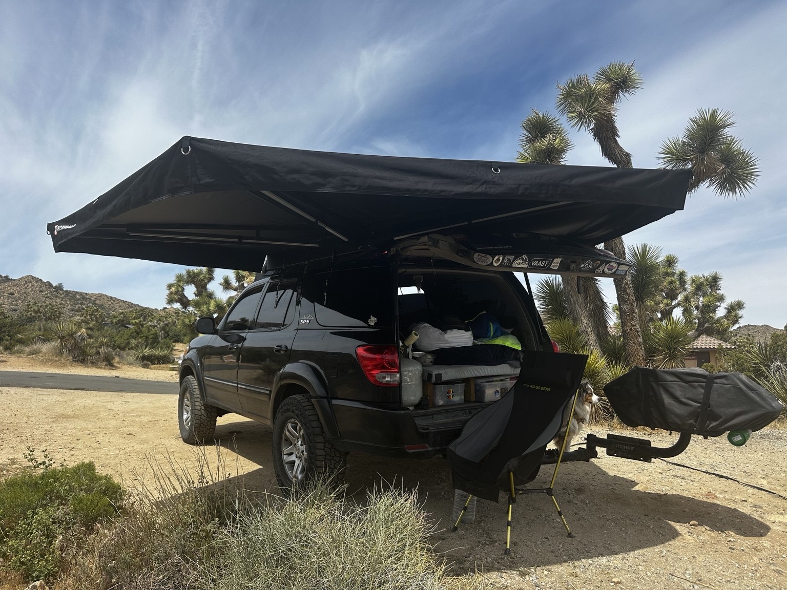 The Sequoia with its awning deployed at a desert campsite.