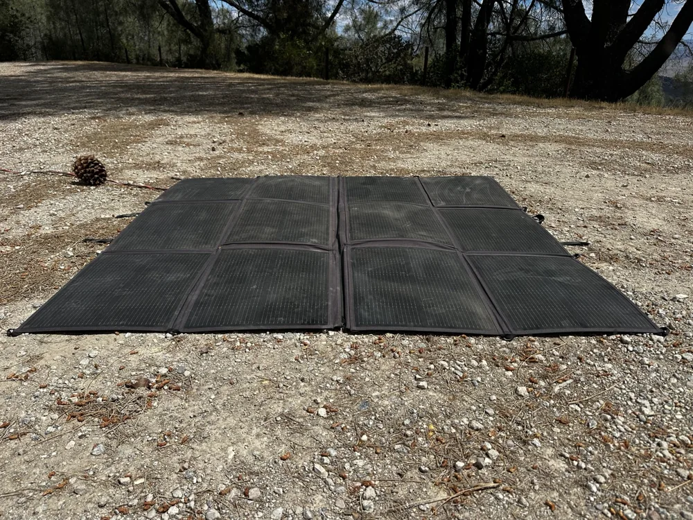 Portable solar panels deployed on the ground at Erik’s campsite.
