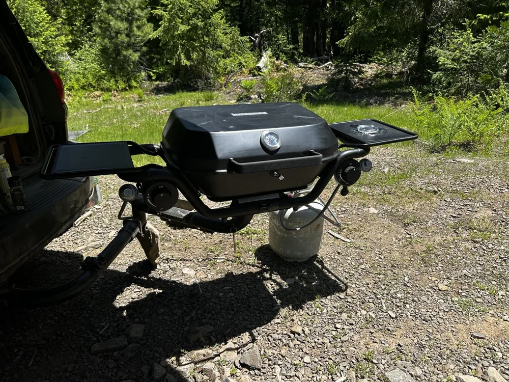 The HitchFire grill set up for cooking behind the Sequoia.