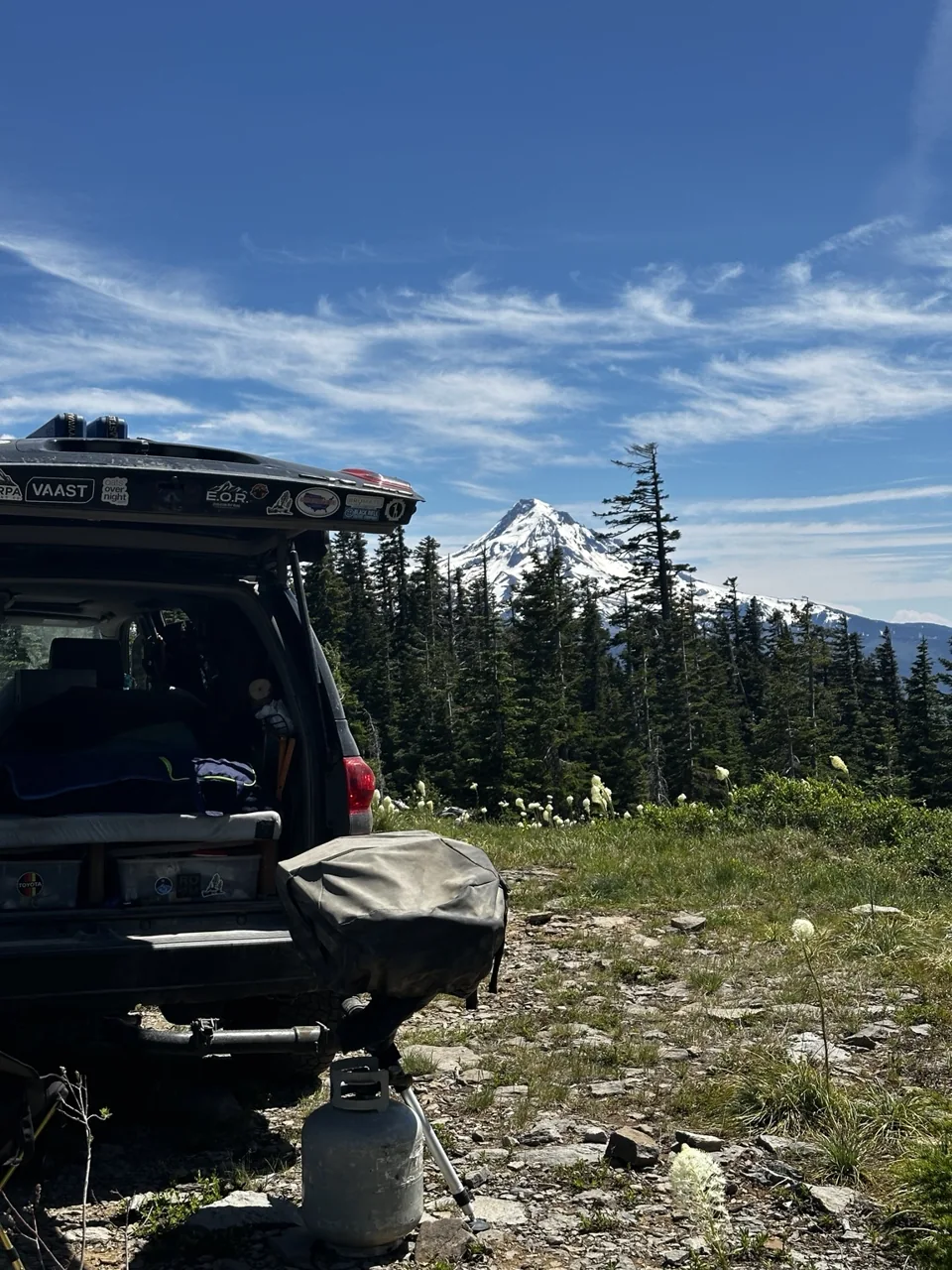 The open rear of the black Sequoia at a mountain campsite.