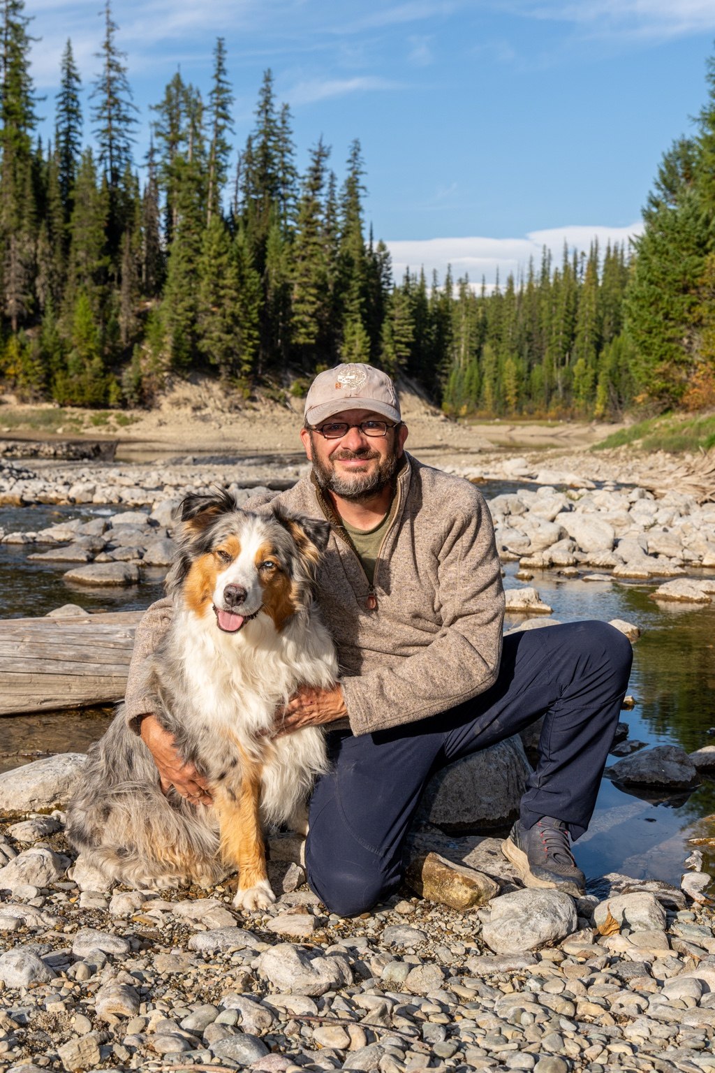 Erik and Sydney sitting together beside a rocky creek.